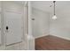 Bright foyer with wood floors, white door and column, and coat hooks at 9568 W San Juan Cir # 203, Littleton, CO 80128