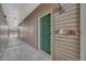 Exterior hallway featuring unit 203's green front door, complete with a doorbell and fire alarm at 9568 W San Juan Cir # 203, Littleton, CO 80128