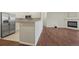 Open-concept kitchen with stainless steel appliances, granite countertops, and an attached living space at 9568 W San Juan Cir # 203, Littleton, CO 80128