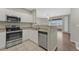 Modern kitchen featuring stainless steel appliances, granite countertops, and white cabinets at 9568 W San Juan Cir # 203, Littleton, CO 80128