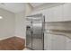 Kitchen showcases stainless steel refrigerator with water and ice dispenser and white cabinets at 9568 W San Juan Cir # 203, Littleton, CO 80128