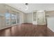 Light-filled living room features hardwood floors, sliding glass doors and built-in shelving at 9568 W San Juan Cir # 203, Littleton, CO 80128