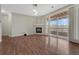 Spacious living room with a cozy fireplace and sliding glass doors leading to a balcony at 9568 W San Juan Cir # 203, Littleton, CO 80128
