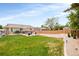 Expansive backyard with a well-manicured lawn, inviting patio, and privacy fence, perfect for outdoor activities at 2027 S Welch Cir, Lakewood, CO 80228