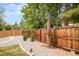 Well-maintained backyard fence with decorative plants and gravel landscaping, enhancing privacy and visual appeal at 2027 S Welch Cir, Lakewood, CO 80228