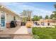 Spacious backyard with patio, seating area, grill, and lush greenery, ideal for outdoor entertaining and relaxation at 2027 S Welch Cir, Lakewood, CO 80228