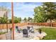 Relaxing backyard patio with comfortable seating, complemented by lush greenery and a well-maintained wooden fence at 2027 S Welch Cir, Lakewood, CO 80228
