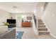 Inviting basement area with a cozy seating, TV, and staircase, perfect for entertainment and relaxation at 2027 S Welch Cir, Lakewood, CO 80228