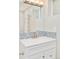 Stylish bathroom featuring a modern vanity with decorative backsplash, creating a clean and sophisticated look at 2027 S Welch Cir, Lakewood, CO 80228