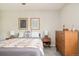 Bedroom features a decorative blanket, dresser and natural light at 2027 S Welch Cir, Lakewood, CO 80228