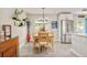 Dining room showcasing a wooden table, stainless steel refrigerator, and natural light from a window at 2027 S Welch Cir, Lakewood, CO 80228