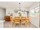 Bright dining area with a wooden table set, pendant lighting, and accent decor for stylish entertaining at 2027 S Welch Cir, Lakewood, CO 80228