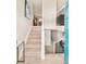 Inviting home entryway showcasing a staircase with wood steps and a modern railing design at 2027 S Welch Cir, Lakewood, CO 80228