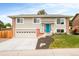 Charming two-story home featuring a blue front door, brick accents, and a well-manicured front yard at 2027 S Welch Cir, Lakewood, CO 80228