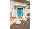 Modern front door with a pop of color and well-maintained landscaping around the entryway at 2027 S Welch Cir, Lakewood, CO 80228