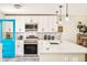 Bright kitchen features white cabinets, stainless steel appliances, stylish backsplash and a modern design at 2027 S Welch Cir, Lakewood, CO 80228