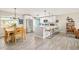 Open concept living space with dining table, kitchen island, and seating area at 2027 S Welch Cir, Lakewood, CO 80228