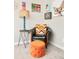 Charming reading nook with a comfortable armchair, colorful decor, and unique lighting, creating a cozy retreat at 2027 S Welch Cir, Lakewood, CO 80228