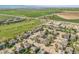 An aerial shot showcases a neighborhood with homes adjacent to farmland and green spaces at 1404 Tonkin Pl, Longmont, CO 80504