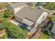 Aerial view of a backyard featuring a wooden deck with awning and a stone patio at 1404 Tonkin Pl, Longmont, CO 80504