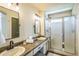 Bright bathroom features double sinks with modern faucets and a glass-enclosed shower at 1404 Tonkin Pl, Longmont, CO 80504