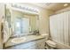 Clean bathroom featuring a vanity with a large mirror and shower/tub combo at 1404 Tonkin Pl, Longmont, CO 80504