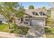 Charming home featuring a covered front porch, dormer windows, and a well-maintained lawn at 1404 Tonkin Pl, Longmont, CO 80504