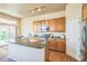 Functional kitchen with stainless steel appliances, breakfast bar, and wood cabinets at 1404 Tonkin Pl, Longmont, CO 80504
