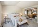 Relaxing main bedroom featuring a comfortable bed, seating area, and access to built-in cabinets and fireplace at 1404 Tonkin Pl, Longmont, CO 80504