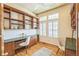 Bright home office with custom built-ins, hardwood floors, and abundant natural light at 1404 Tonkin Pl, Longmont, CO 80504