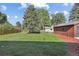 Spacious backyard with green grass and a shed at 280 Ammons St, Lakewood, CO 80226