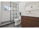 Modern bathroom with a walk-in shower with black grid, a unique vanity, and stylish tile flooring at 280 Ammons St, Lakewood, CO 80226