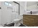 Modern bathroom featuring a glass-enclosed shower, vanity, and tiled floors at 280 Ammons St, Lakewood, CO 80226