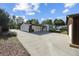 View of the property featuring a concrete driveway and ample parking spaces at 280 Ammons St, Lakewood, CO 80226