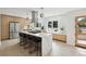 Modern kitchen featuring a large island with seating, stainless steel appliances, and ample natural light at 280 Ammons St, Lakewood, CO 80226