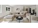 Cozy living room featuring a large sectional sofa, modern coffee table, and natural light at 280 Ammons St, Lakewood, CO 80226