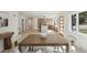 Open floor plan with the kitchen in the background and dining table in the foreground with lots of light at 280 Ammons St, Lakewood, CO 80226