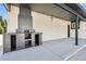 Covered outdoor patio with an inviting fireplace for entertaining at 280 Ammons St, Lakewood, CO 80226