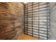 Rustic wine cellar featuring wood paneling and a metal rack system for ample bottle storage at 280 Ammons St, Lakewood, CO 80226