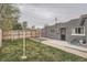 Back exterior of home and fenced yard with gravel area at 3930 W Kentucky Ave, Denver, CO 80219