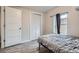 A comfy bedroom with hardwood floors, a window for light, and a built-in closet for storage at 3930 W Kentucky Ave, Denver, CO 80219