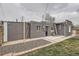 Back exterior of home and fenced yard with gravel area at 3930 W Kentucky Ave, Denver, CO 80219