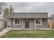 Charming home featuring a cozy front porch, well-maintained lawn, and updated stonework at 3930 W Kentucky Ave, Denver, CO 80219