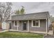 Charming covered front porch with stone accents and white support beams welcomes you home at 3930 W Kentucky Ave, Denver, CO 80219