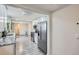 Bright kitchen featuring white cabinets, stainless steel appliances, and granite countertops at 3930 W Kentucky Ave, Denver, CO 80219