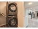 Stacked washer and dryer located near the kitchen area, maximizing space at 3930 W Kentucky Ave, Denver, CO 80219