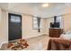 Living room showcasing a decorative door, wood-look floors and natural light at 3930 W Kentucky Ave, Denver, CO 80219
