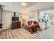 Comfortable living room with wood-look floors and a view of the kitchen at 3930 W Kentucky Ave, Denver, CO 80219