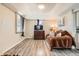 Comfortable living room with wood-look floors and a view of the kitchen at 3930 W Kentucky Ave, Denver, CO 80219