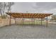 A parking area with a covered shelter and a gravel base at 3930 W Kentucky Ave, Denver, CO 80219